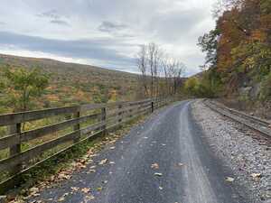 Railway near tree-lined hill