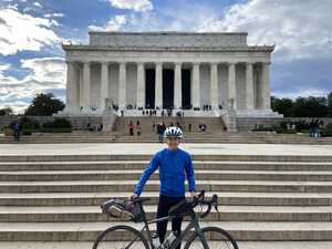 Man with bike in front of memorial