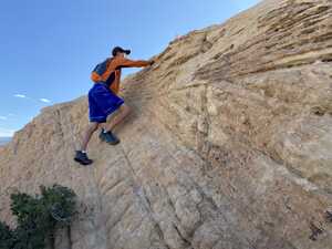 Man climbing down rock face