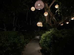 Wicker lanterns at night hanging over path