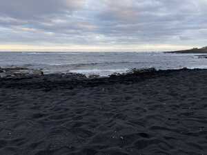 Black sand beach, looking into ocean
