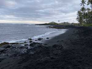 Black sand beach, looking into cove
