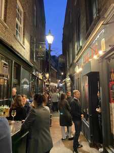 Crowded alleyway lined with pubs