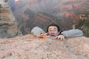 Man pretending to fall off canyon