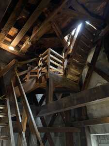 Wooden staircase inside stone tower