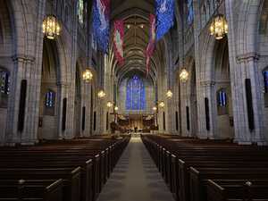 Gothic stone church with blue stained glass windows