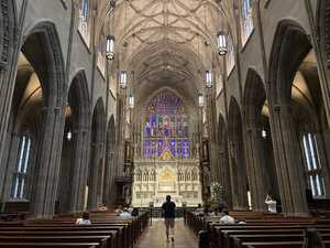 Gothic stone church with stained glass and altar