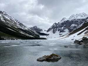 Frozen lake in front of mountains