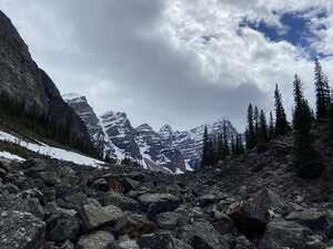 Boulders in valley with snow-capped peaks behind