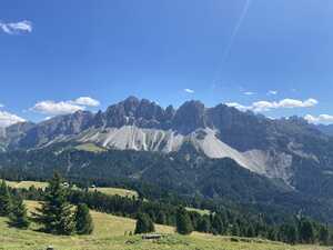 Mountain ridge rising above tree-lined valley