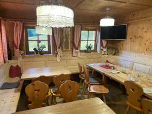 Cozy wood-paneled dining room with views to grass outside