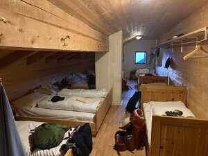 Dorm room with beds and low ceiling