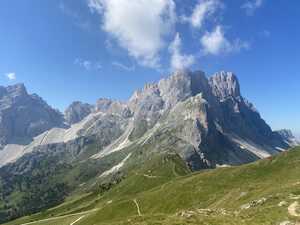 Mountain group rising over grassy slopes on clear day