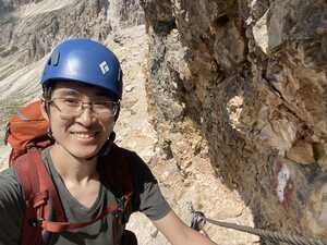 Asian man with climbing helmet on rock