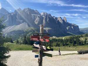 Signpost with colorful arrows pointing at major cities