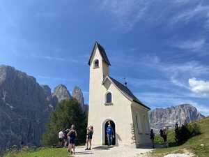 Plain beige chapel in front of mountains