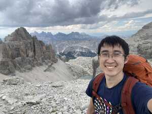 Asian man in front of mountains