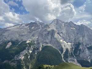 Large mountain with trees on lower half