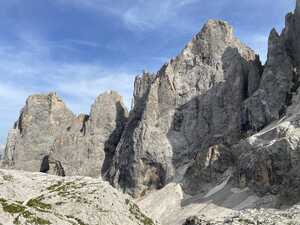 Gray, rocky mountain peak against blue sky