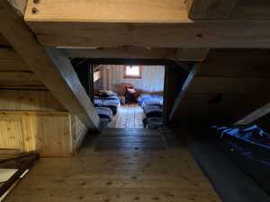 Low wooden attic ceiling leading into dorm room