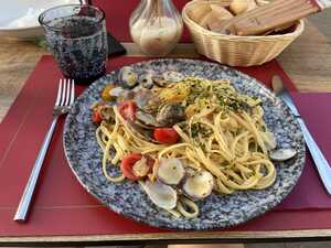 Plate of pasta with seafood on restaurant table