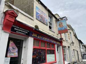 Red pub among white houses with retro banner