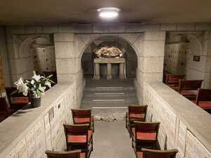 Underground chapel with simple wooden chairs and stone