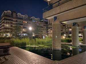 Concrete courtyard with pool and plants