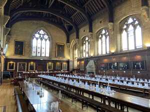 Old dining hall with timber roof and wooden tables