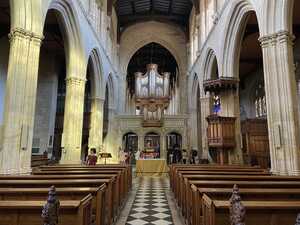 Stately church interior with pipe organ in background