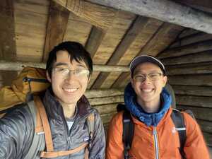 Two Asian men in a wooden hut