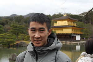 Portrait of Asian man with golden building in background